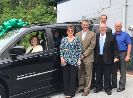 Reliable Auto Body donating a handicapped-accessible van to a local military family in 2017